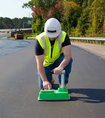 worker conducting asphalt testing