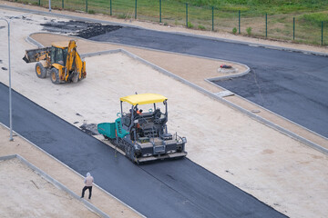 asphalt being applied to a parking lot